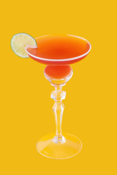 Cosmopolitan cocktail on yellow background - Fotó, kép