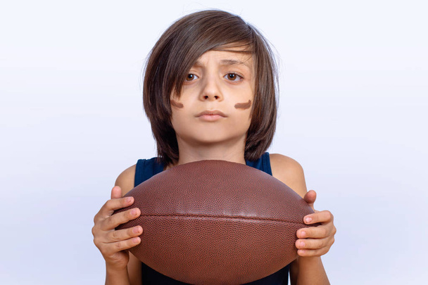 Little boy with american football ball. - Фото, зображення