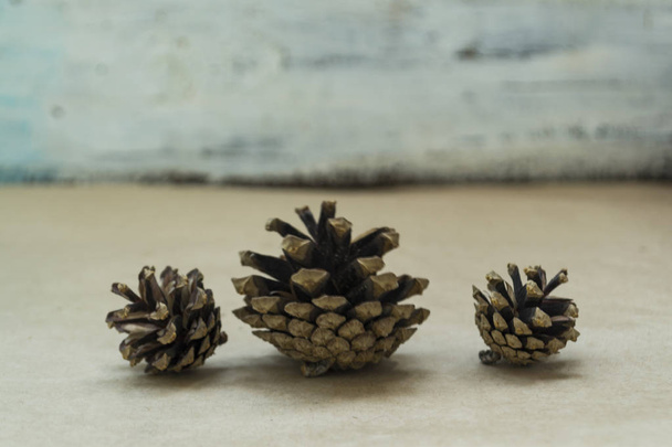 Three spruce cones lies on the craft background. The concept of winter and Christmas - Foto, Bild