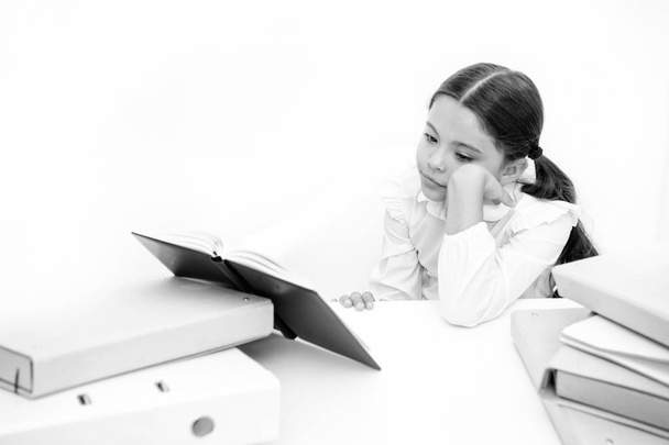 Boring task homework. Get rid of boring task. Girl bored pupil sit at desk with folders and books. Issues of formal education. Back to school concept. Kid cute tired of studying. Boring lesson - Photo, image