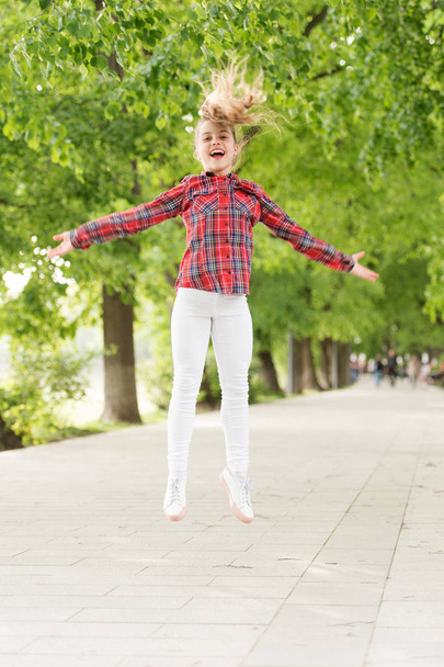 Fresh air gives her the vital energy. High energy or hyperactive kid. Small girl jumping in casual fit for energetic activity. Energy concept. Healthy lifestyle gives child the energy - Zdjęcie, obraz