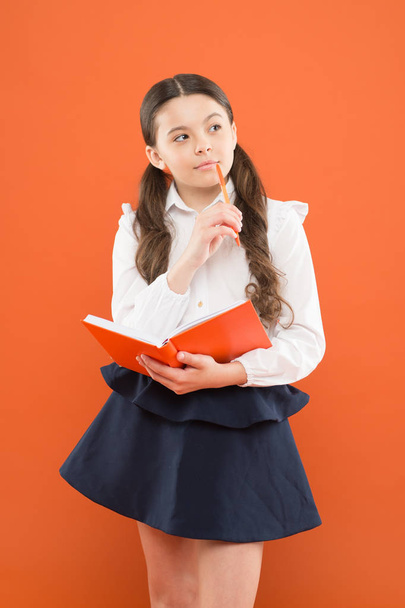School lesson. Child doing homework. Your career path begins here. Inspiration for study. Back to school. Knowledge day. Possible everything. Schoolgirl enjoy study. Kid school uniform hold workbook - 写真・画像