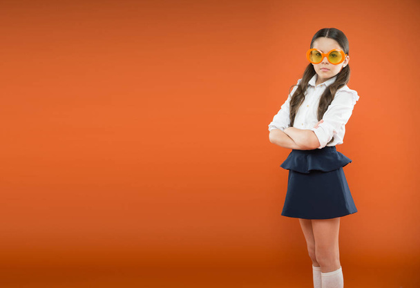 Prepare kid first school day. Schoolgirl cute ponytails. Excellent pupil concept. Girl wear school uniform orange background. School education. Lets begin school year. Perfect schoolgirl tidy hair - Fotó, kép