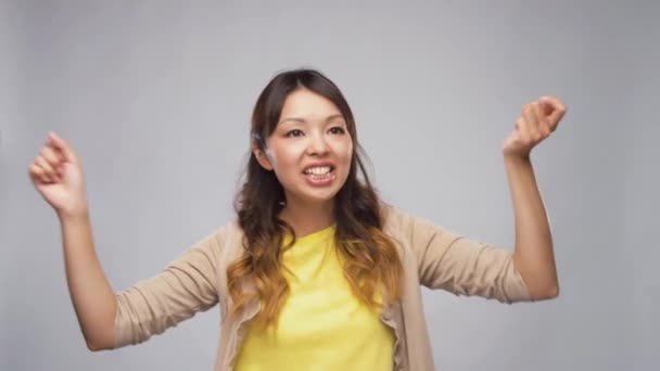 joyful asian woman dancing - Felvétel, videó