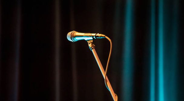 Microphone on stage against a background of auditorium. - Fotografie, Obrázek