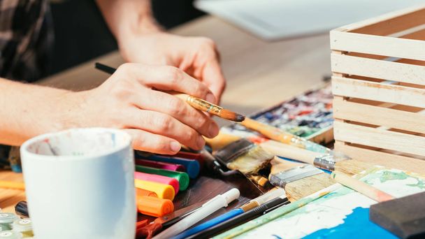 artist tools paintbrushes markers hands workplace - Fotografie, Obrázek