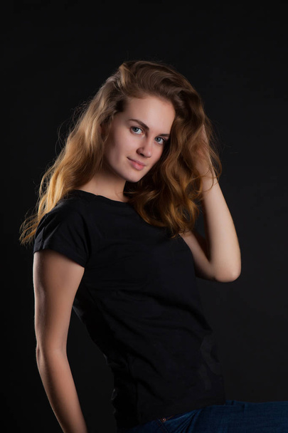 closeup portrait of a young, beautiful woman on a black background - Φωτογραφία, εικόνα