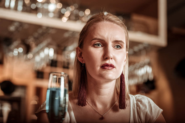 Serious young female going to drink champagne - Fotografie, Obrázek