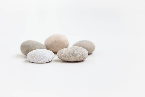 Set of five pebbles on the white background - Фото, изображение
