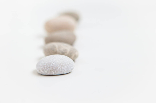 Set of five pebbles in a row on the white background - Zdjęcie, obraz