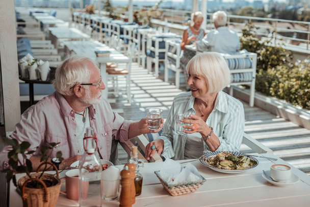 Cheerful elderly people having date on the terrace - Photo, Image
