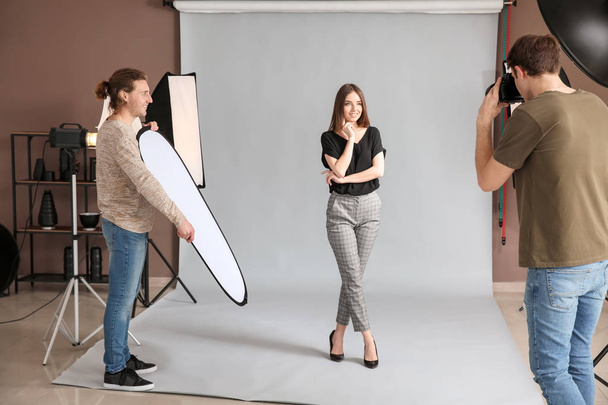 Professional photographer working with model in studio - Foto, Imagem