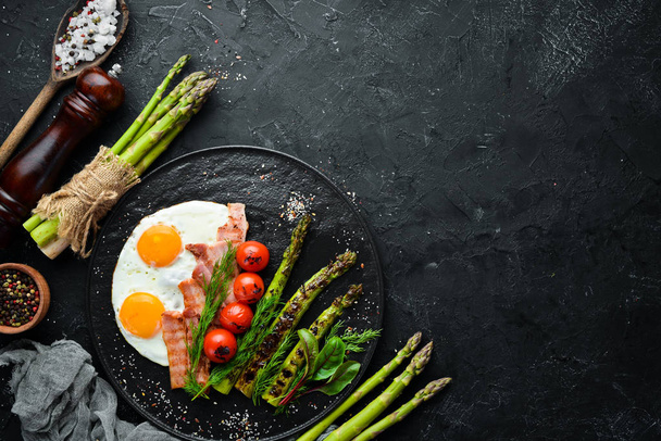 Breakfast. Asparagus, eggs, bacon and cherry tomatoes. Healthy food. Top view. Free space for your text. - Fotografie, Obrázek
