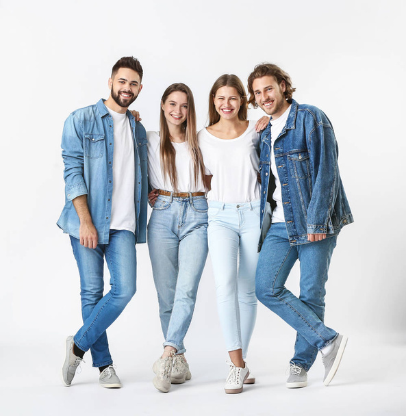 Стильные молодые люди в джинсовой одежде на белом фоне
 - Фото, изображение