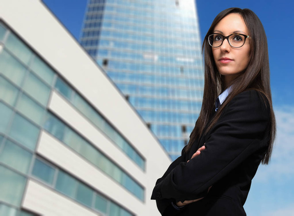 Business, young smiling businesswoman outdoor in a modern city setting - Photo, image