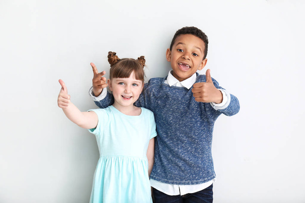 Portrait of cute children showing thumb-up on white background - Photo, Image