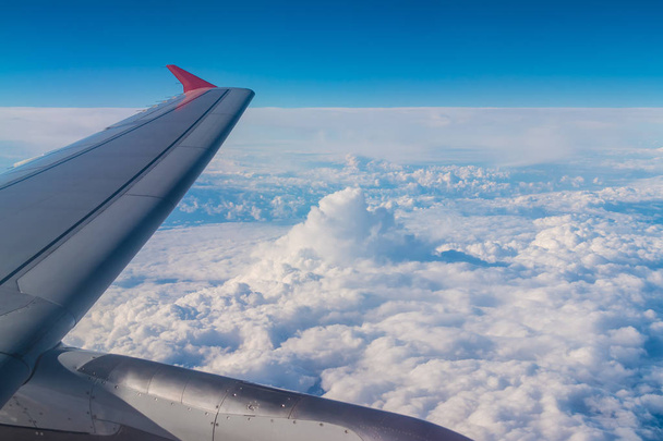 Wing of airplane above clouds - Fotó, kép
