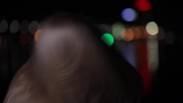 Beautiful blonde model with long hair posing in night city - Materiał filmowy, wideo
