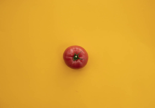 Close up ripe tomato on bright yellow background top view flat l - Фото, зображення