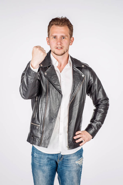 portrait of young man in black eather jacket isolated on a white - Foto, afbeelding