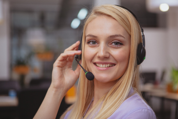 Friendly customer support operator with headset working at call  - Photo, Image
