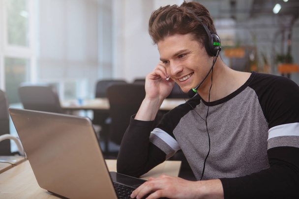 Friendly customer support operator with headset working at call  - Φωτογραφία, εικόνα