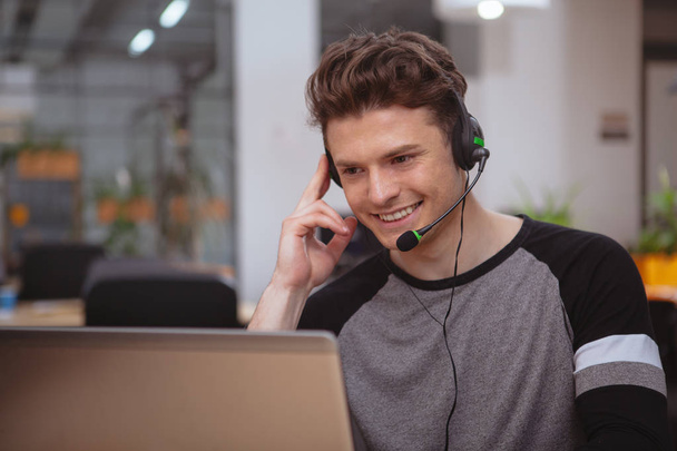 Friendly customer support operator with headset working at call  - Photo, Image