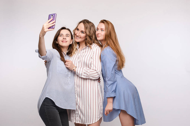 Gorgeous slim friends taking selfie via mobile. - Photo, Image