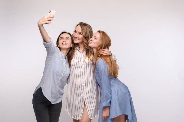 Gorgeous slim friends taking selfie via mobile. - Photo, Image
