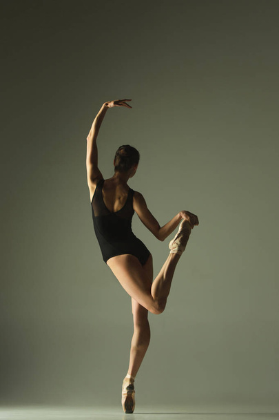 Young graceful female ballet dancer dancing in mixed light - Fotografie, Obrázek