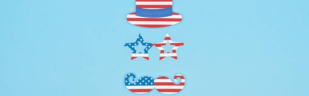 panoramic shot of paper cut mustache, glasses and hat made of usa flags on blue background - Photo, Image
