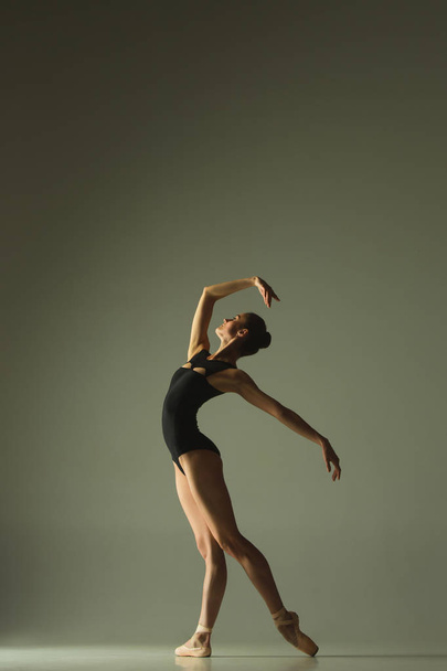 Young graceful female ballet dancer dancing in mixed light - Foto, Imagem