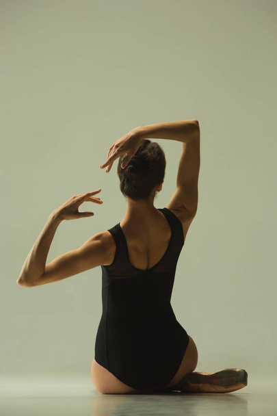 Young graceful female ballet dancer dancing in mixed light - Foto, Imagem
