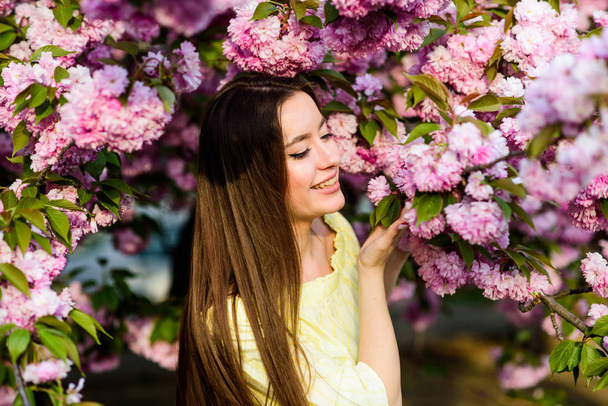 natural summer beauty. skincare and spa. Natural cosmetics for skin. blossom smell, allergy. woman in spring flower bloom. girl in cherry flower. Sakura tree blooming. Great pleasure - Photo, image