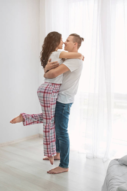 Adorable loving couple in bedroom - Photo, Image