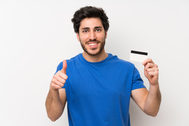 Hombre guapo sosteniendo una tarjeta de crédito
 - Foto, Imagen