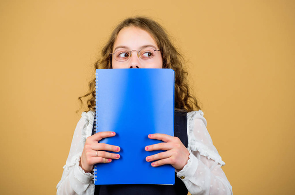 Preparing to exams in library. Small child formal wear. Prepare for exam. Formal education and homeschooling. Check knowledge. School exam concept. Final exam coming. Girl hold textbook folder test - Photo, image