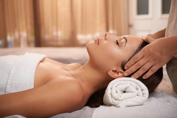 woman massage client face, while woman lying - Foto, Bild