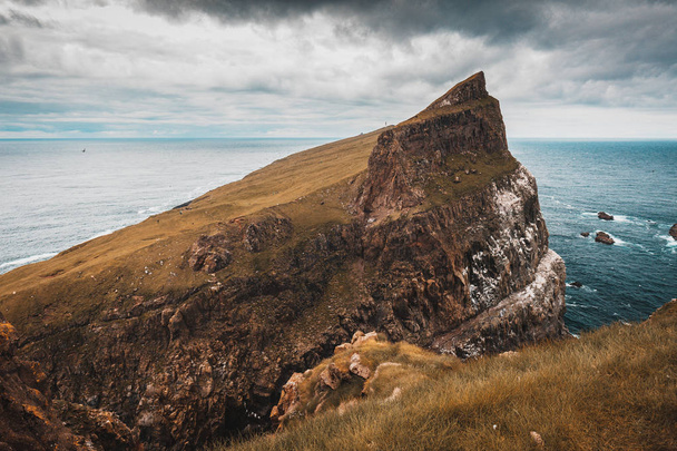 cliffs and the village on the island of Mykines, Faroe. - Fotó, kép