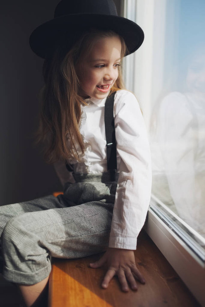 cute little girl with black hat at home - Fotoğraf, Görsel