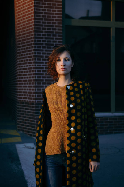 Young woman is wearing polka dot coat - Photo, Image