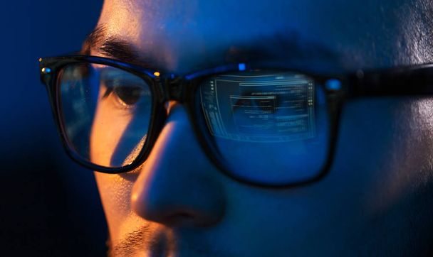 close up of hacker in glasses looking at screen - Foto, Imagen