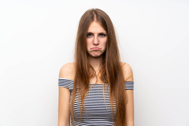 Young woman with long hair over isolated white wall with sad and depressed expression - Foto, immagini