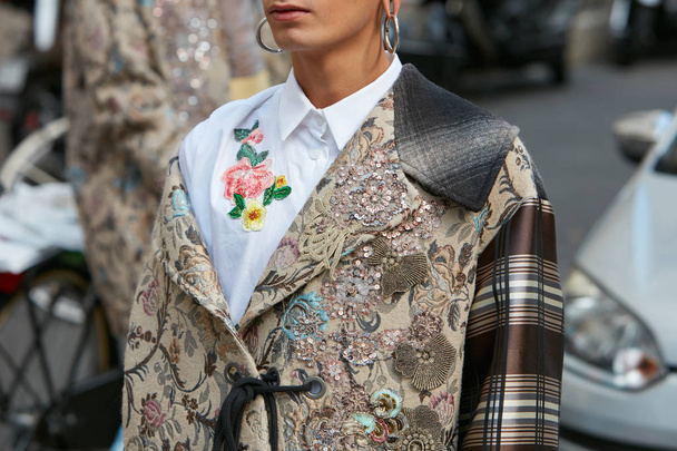Man with beige coat with sequins and floral decoration and large earrings before Antonio Marras fashion show, Milan Fashion Week street style on September 23, 2017 in Milan. - Fotó, kép