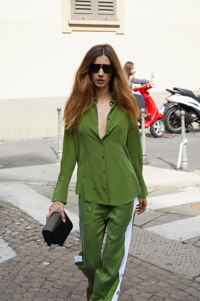 Woman with green shirt, trousers and sunglasses before Antonio Marras fashion show, Milan Fashion Week street style on September 23, 2017 in Milan. - Zdjęcie, obraz