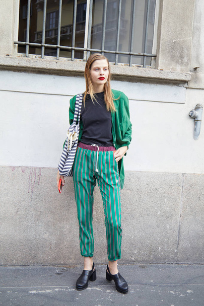 Woman with green trousers and jacket before Ermanno Scervino fashion show, Milan Fashion Week street style on September 23, 2017 in Milan. - Foto, Bild