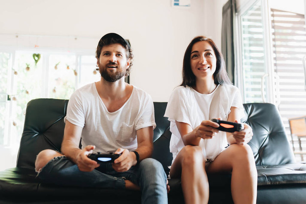 Portrait of funny comic couple holding joy sticks in hands playing video game - Fotoğraf, Görsel