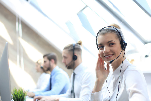 Female customer support operator with headset and smiling. - Fotó, kép