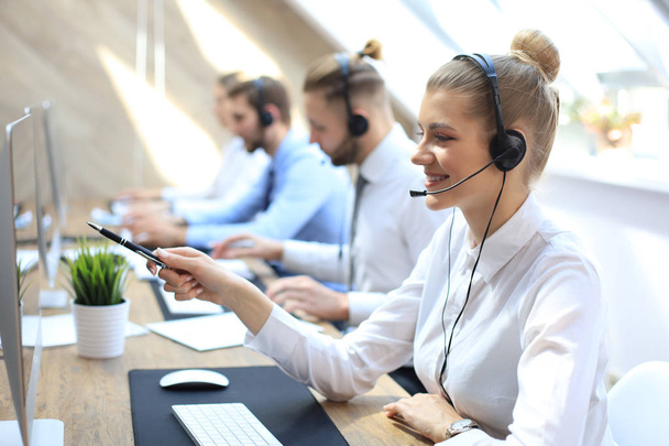 Female customer support operator with headset and smiling. - Φωτογραφία, εικόνα