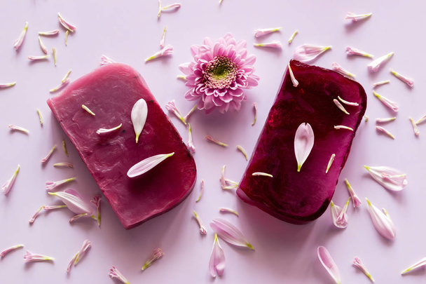 homemade natural soap on a colored background with flower petals - Fotó, kép